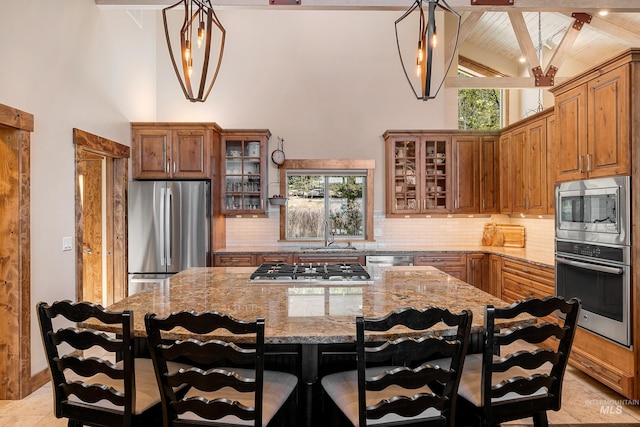 kitchen featuring a center island, light tile flooring, plenty of natural light, and stainless steel appliances