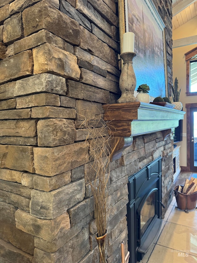 room details featuring tile flooring, a fireplace, and a wood stove