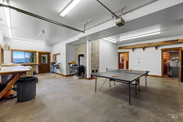 interior space with concrete floors and a wood stove