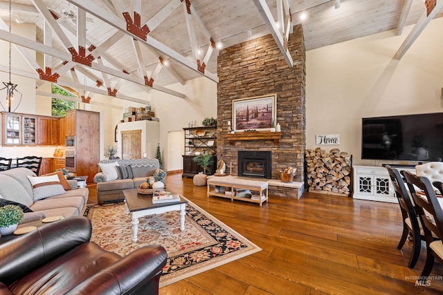 living room with high vaulted ceiling, beam ceiling, a fireplace, and hardwood / wood-style floors