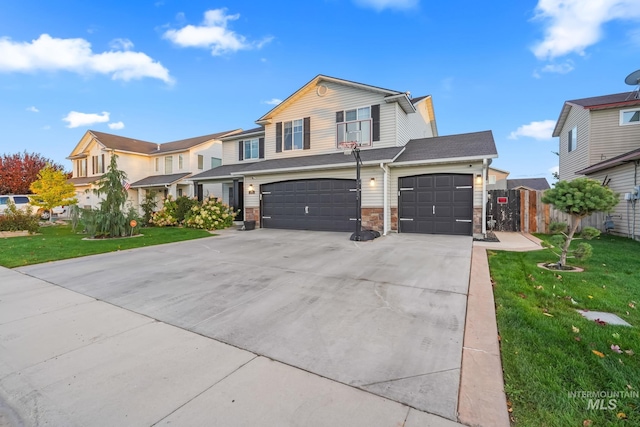 view of front of property featuring fence, concrete driveway, a front yard, stone siding, and an attached garage