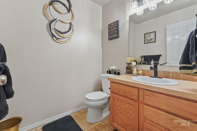 bathroom featuring tile patterned floors, toilet, and vanity