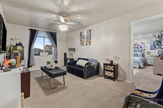 living room with carpet flooring, ceiling fan, a textured ceiling, and baseboards