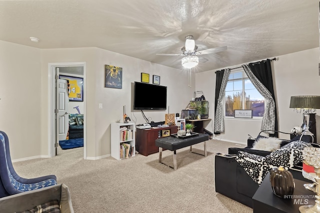 living area featuring a textured ceiling, baseboards, carpet floors, and ceiling fan