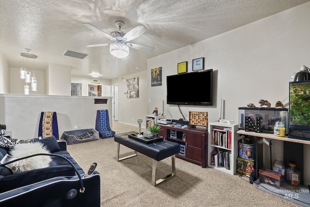 carpeted living room with visible vents, a textured ceiling, and a ceiling fan