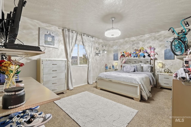 bedroom featuring light colored carpet and a textured ceiling