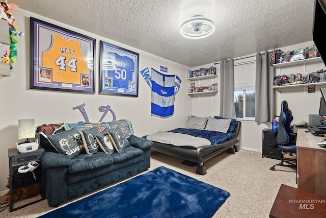 bedroom with baseboards, carpet floors, and a textured ceiling