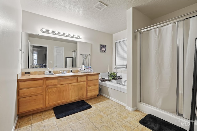 full bath with visible vents, a shower stall, and vanity