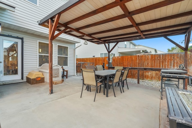 view of patio featuring outdoor dining space and fence