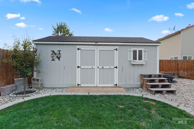 view of shed with a fenced backyard