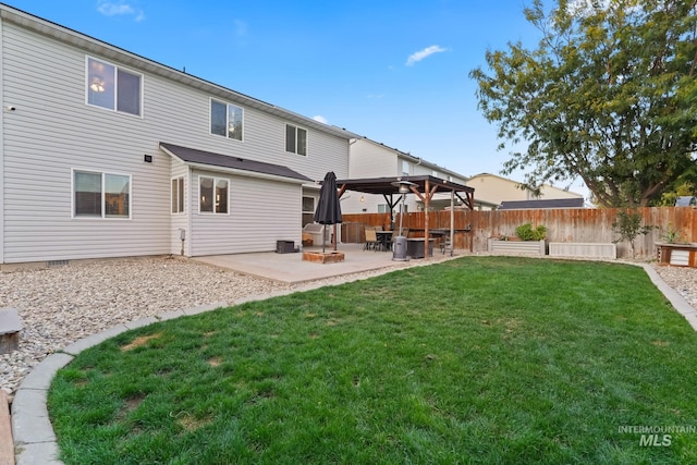 rear view of house with a patio area, a lawn, a gazebo, and fence