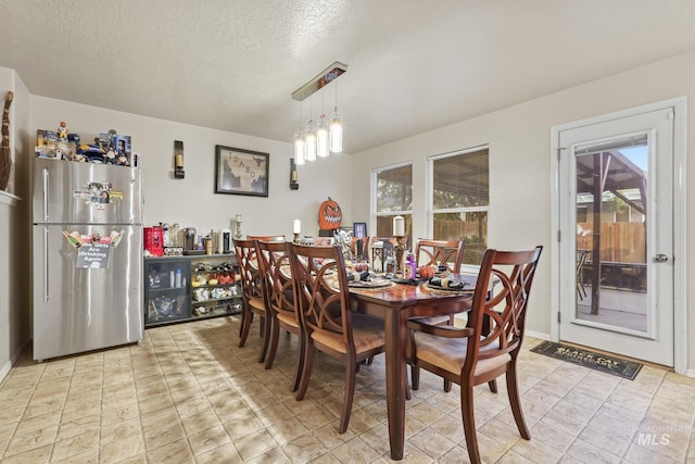 dining area with a textured ceiling