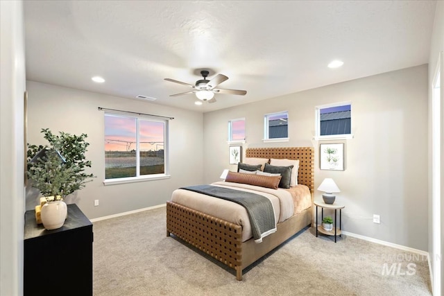 bedroom with ceiling fan and light carpet