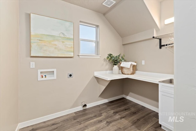 washroom featuring dark hardwood / wood-style flooring, hookup for a washing machine, and hookup for an electric dryer