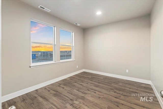 spare room with dark hardwood / wood-style floors