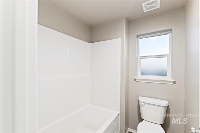 bathroom with shower / bathing tub combination and toilet