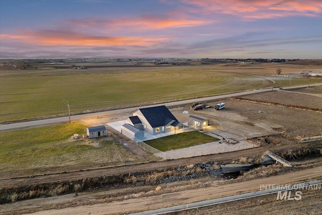 aerial view at dusk featuring a rural view