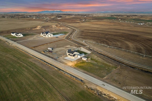 aerial view at dusk featuring a rural view