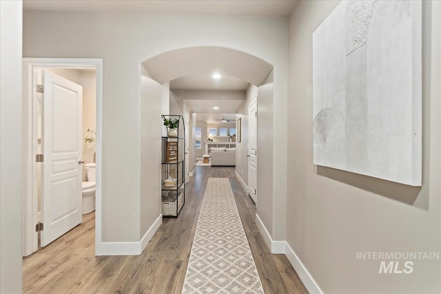 corridor with hardwood / wood-style flooring