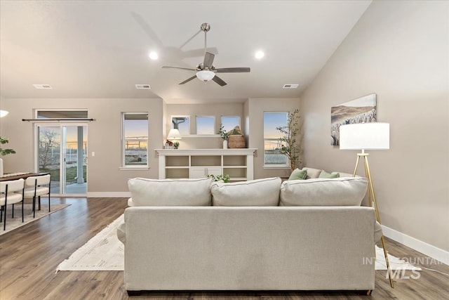 living room with hardwood / wood-style flooring, vaulted ceiling, and ceiling fan