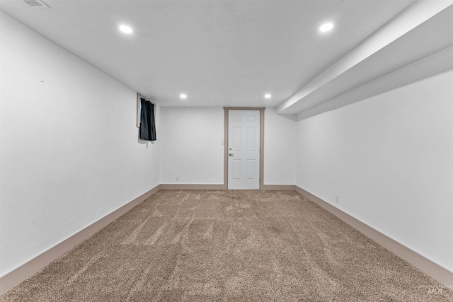 finished basement featuring recessed lighting and light carpet