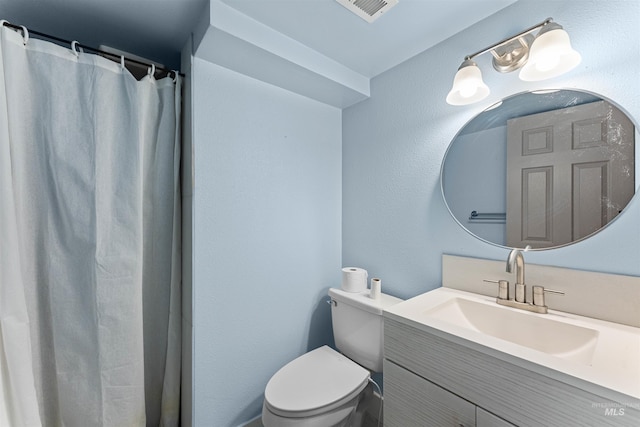 bathroom featuring toilet, visible vents, and vanity