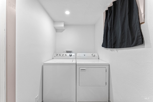 washroom featuring laundry area and washer and clothes dryer