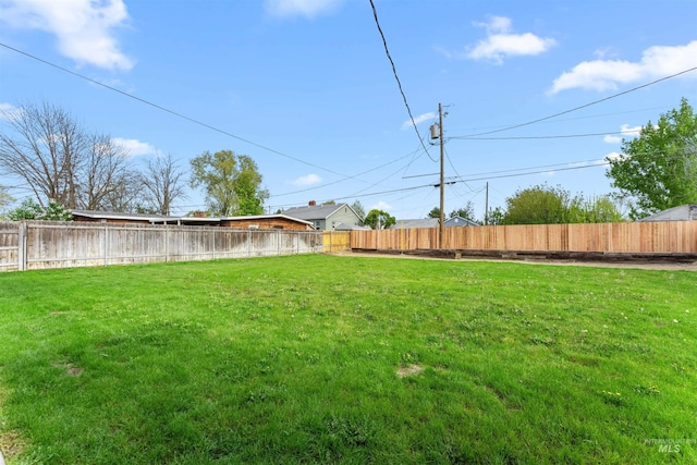 view of yard with a fenced backyard