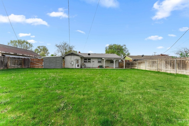 rear view of house featuring a fenced backyard and a yard