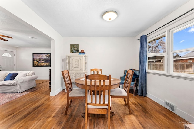 dining space with visible vents, baseboards, light wood finished floors, and a wealth of natural light