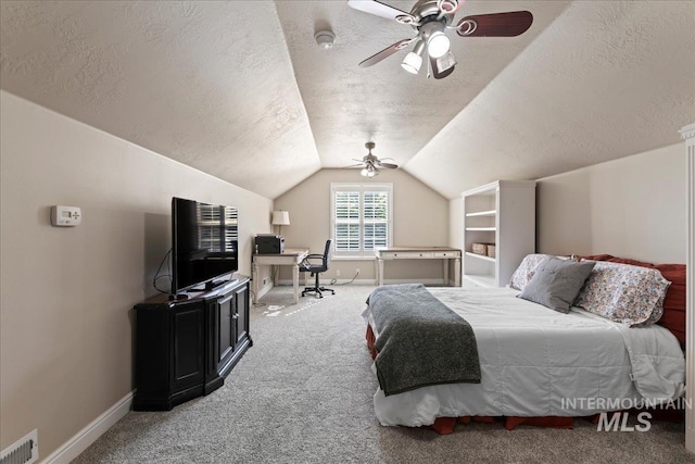 bedroom with carpet, a textured ceiling, vaulted ceiling, and ceiling fan