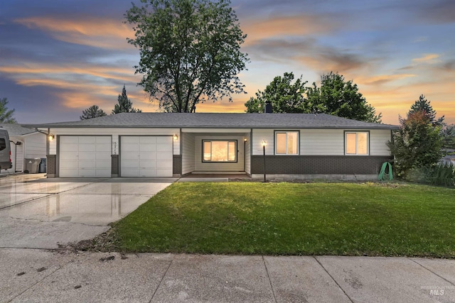 5715 W Winfield Ct, Boise, ID 83703 - ranch-style house featuring an attached garage, driveway, a front lawn, and brick siding