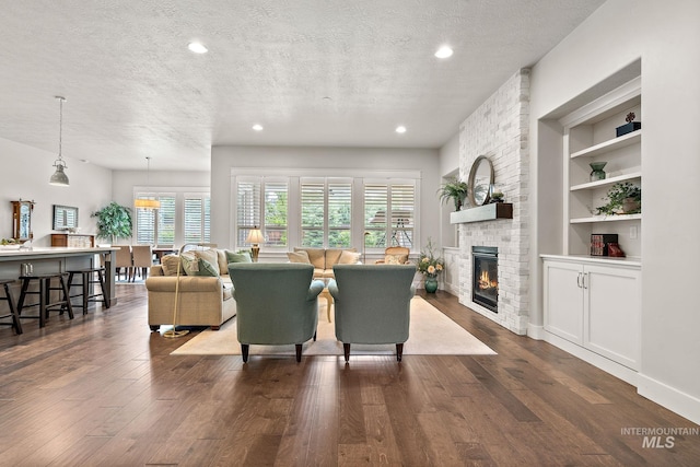 6922 N Agrarian, Meridian, ID 83646 - living area with a textured ceiling, dark wood finished floors, a fireplace, recessed lighting, and built in shelves