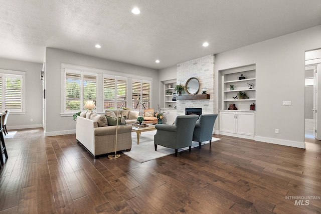 6922 N Agrarian, Meridian, ID 83646 - living area with a textured ceiling, dark wood-type flooring, baseboards, a large fireplace, and recessed lighting