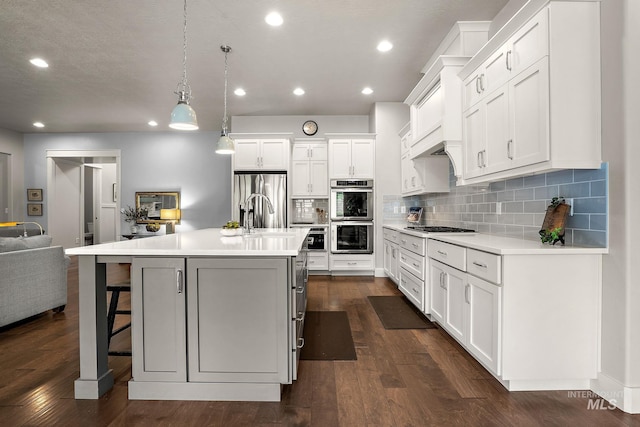 6922 N Agrarian, Meridian, ID 83646 - kitchen featuring appliances with stainless steel finishes, light countertops, recessed lighting, backsplash, and dark wood-style flooring