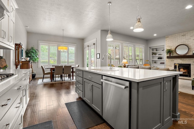 6922 N Agrarian, Meridian, ID 83646 - kitchen featuring gray cabinetry, dishwasher, a sink, a textured ceiling, and light countertops