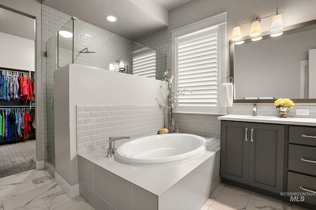 6922 N Agrarian, Meridian, ID 83646 - bathroom featuring marble finish floors, a stall shower, vanity, a garden tub, and recessed lighting