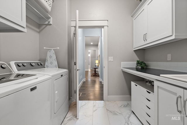 6922 N Agrarian, Meridian, ID 83646 - washroom featuring washing machine and dryer, cabinet space, light marble finish flooring, and baseboards