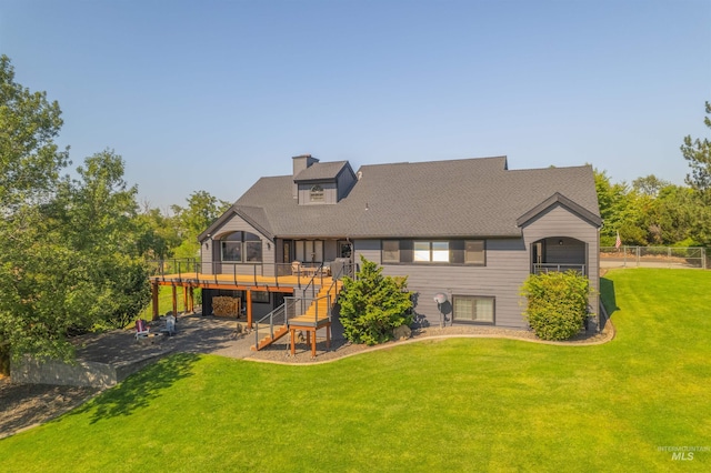 rear view of house with a patio area, a deck, and a lawn