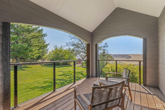 wooden terrace featuring a yard