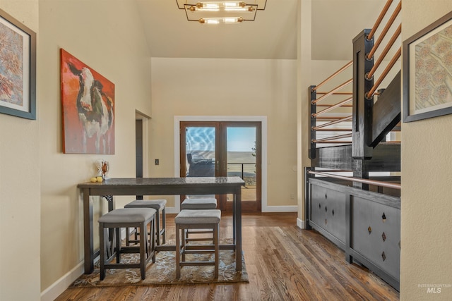 dining area with an inviting chandelier and dark hardwood / wood-style floors