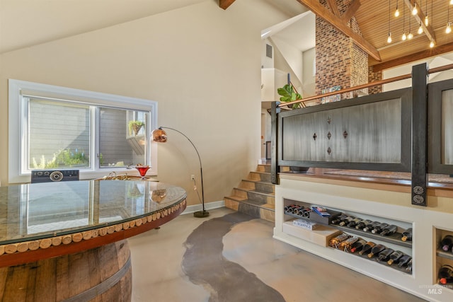 interior space with concrete floors and high vaulted ceiling