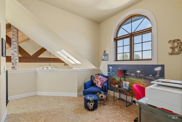 home office featuring vaulted ceiling with skylight