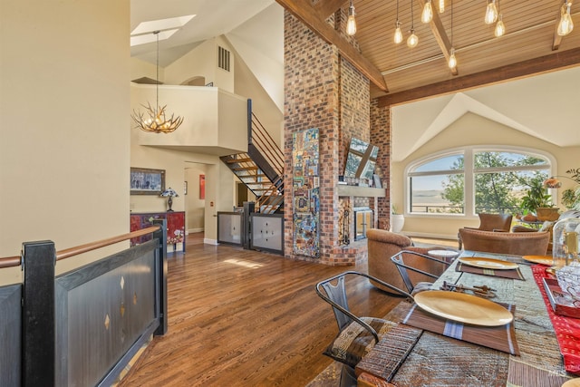 living room with hardwood / wood-style floors, high vaulted ceiling, wooden ceiling, and a brick fireplace