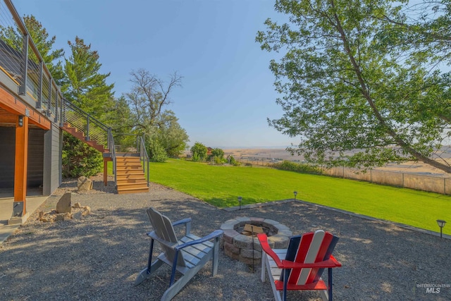 view of patio with an outdoor fire pit and a deck