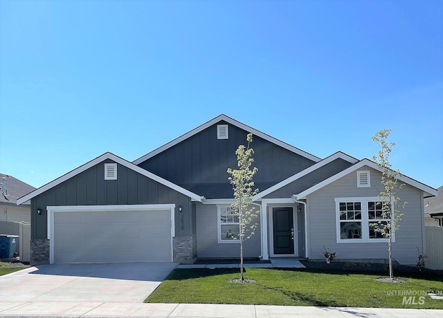 view of front of home featuring a garage and a front lawn