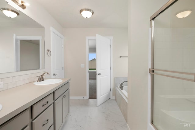 bathroom with vanity and shower with separate bathtub