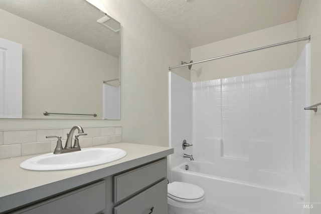 full bathroom with vanity, a textured ceiling, backsplash, shower / tub combination, and toilet