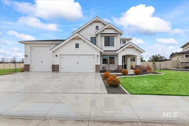 view of front facade featuring concrete driveway, fence, a front yard, board and batten siding, and brick siding