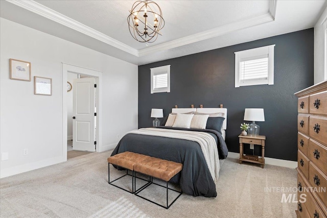 carpeted bedroom with crown molding, a tray ceiling, a notable chandelier, and baseboards